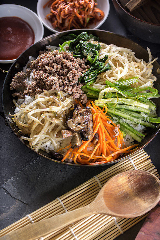 BI Bim Bap，拌菜饭，顶视图与热酱在铸铁锅